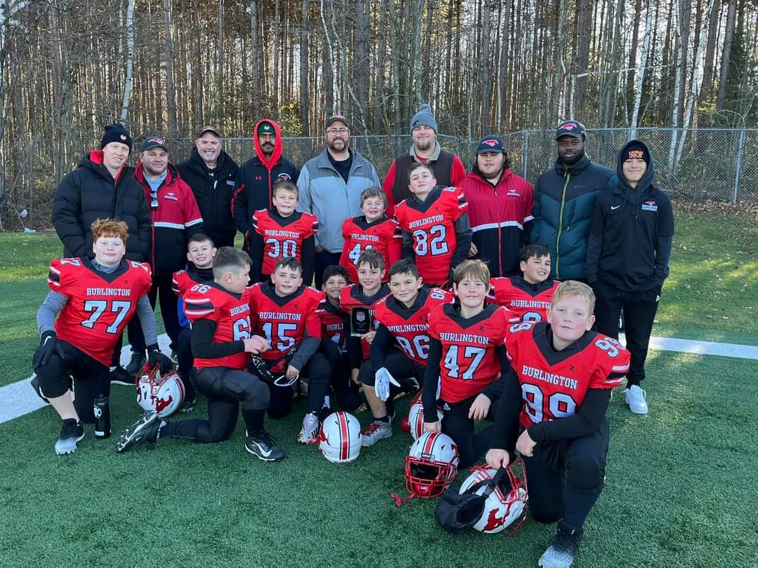 BMFA athletes and coaches gathered on the field for a team photo.